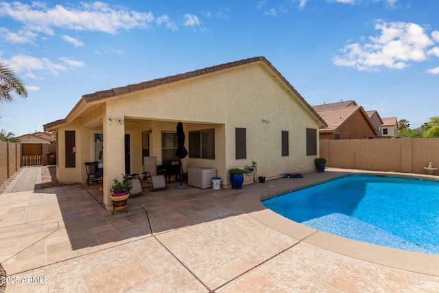 view of swimming pool featuring a fenced backyard, a fenced in pool, and a patio area
