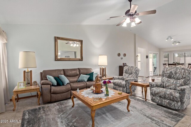 living room featuring a ceiling fan, light tile patterned flooring, and vaulted ceiling