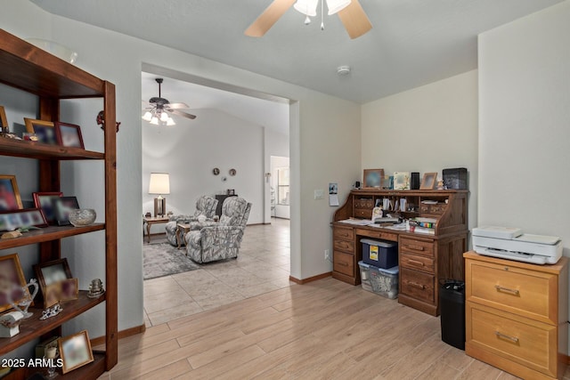 home office featuring ceiling fan, vaulted ceiling, and light wood-type flooring