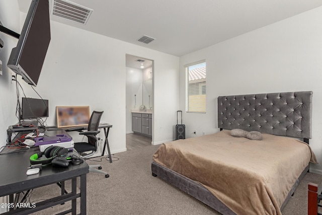 carpeted bedroom featuring connected bathroom, baseboards, and visible vents