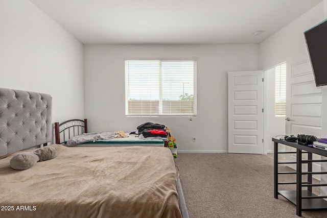 carpeted bedroom featuring baseboards