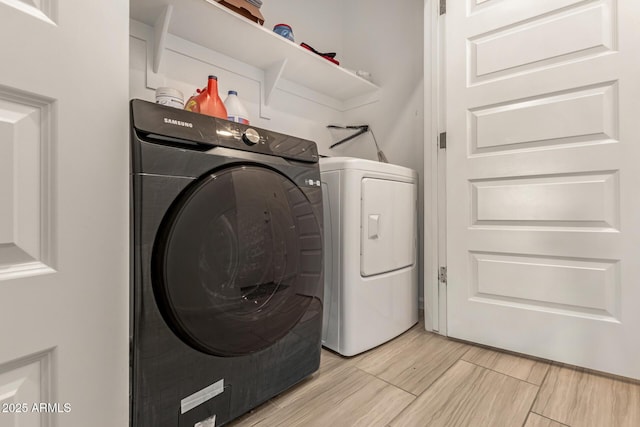 washroom with laundry area, light wood-style floors, and washing machine and dryer