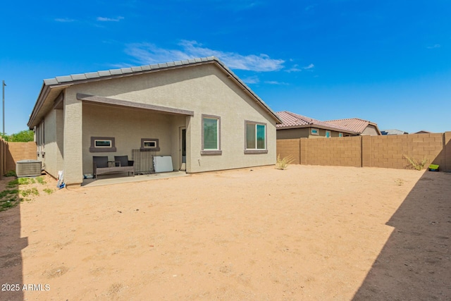 back of property featuring central air condition unit, a fenced backyard, a patio area, and stucco siding