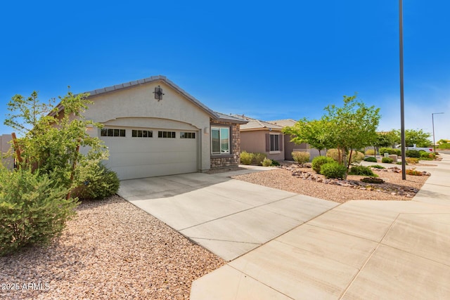 ranch-style home featuring a tiled roof, a garage, stucco siding, and driveway