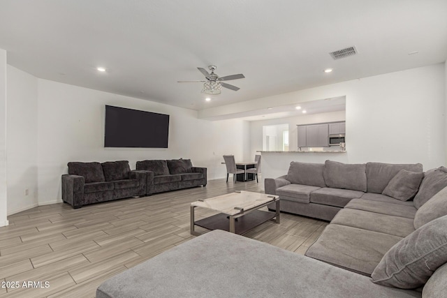 living room featuring visible vents, recessed lighting, and wood finish floors