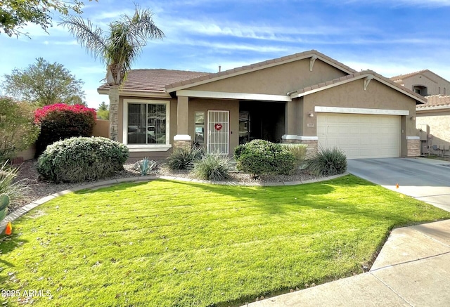 view of front of property featuring a garage, driveway, a front lawn, and stucco siding