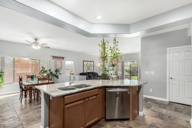 kitchen featuring a sink, a wealth of natural light, dishwasher, and an island with sink