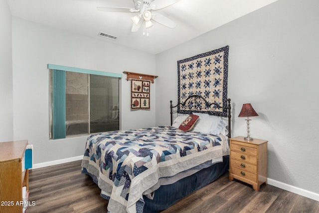 bedroom featuring dark wood-style floors, a ceiling fan, visible vents, and baseboards