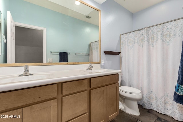 bathroom with toilet, double vanity, a sink, and visible vents