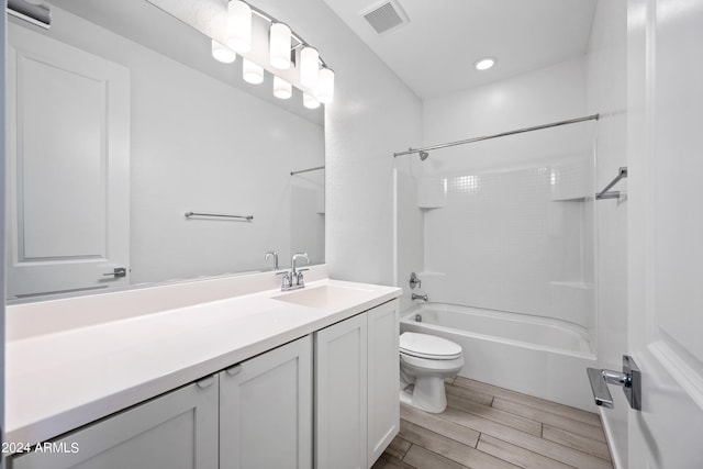 full bath featuring bathtub / shower combination, toilet, vanity, visible vents, and wood tiled floor