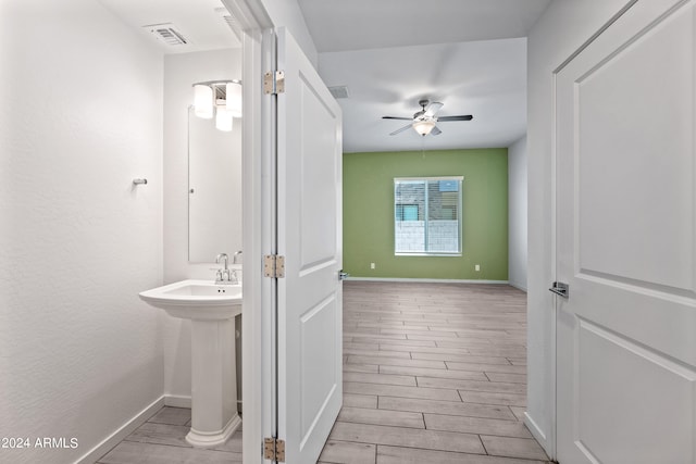 bathroom featuring ceiling fan, wood finish floors, visible vents, and baseboards