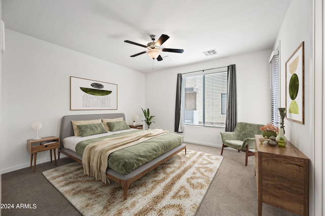 bedroom with carpet floors, visible vents, ceiling fan, and baseboards