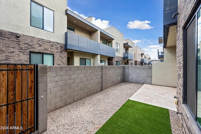 view of yard with a fenced backyard, a residential view, and a patio