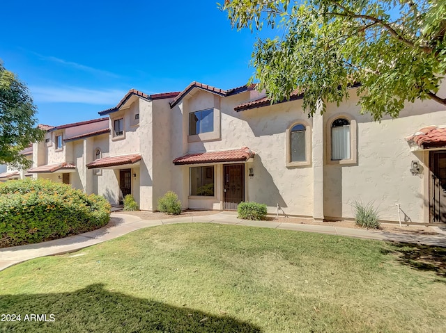 mediterranean / spanish home featuring a front yard