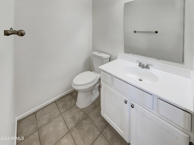 bathroom featuring tile patterned flooring, vanity, and toilet