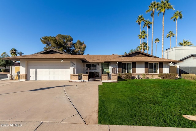 single story home with a garage and a front lawn