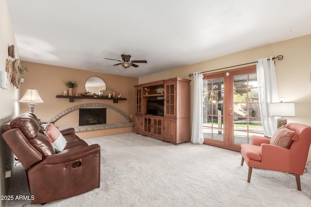 living room featuring carpet floors, ceiling fan, and french doors