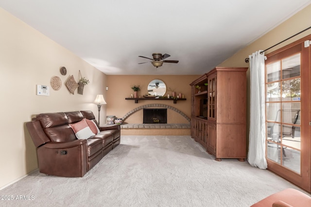 carpeted living room with ceiling fan