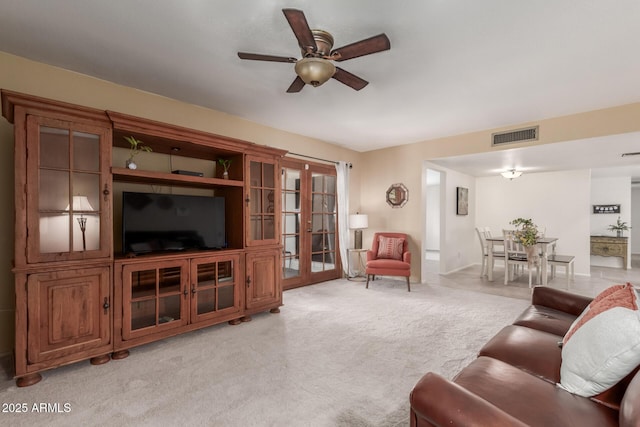 living room featuring ceiling fan and light carpet