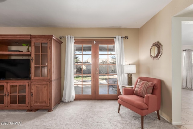 sitting room with light carpet and french doors