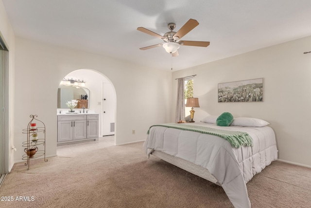 carpeted bedroom with ceiling fan and connected bathroom