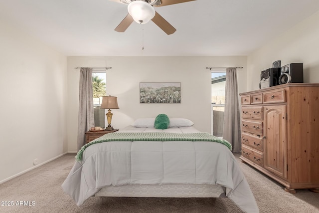 carpeted bedroom with ceiling fan and multiple windows