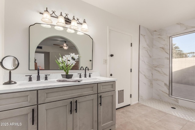 bathroom featuring vanity, ceiling fan, tiled shower, and tile patterned floors