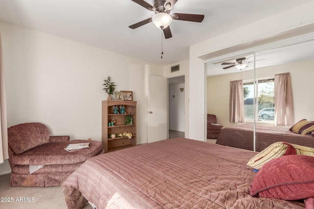 bedroom with ceiling fan, carpet, and a closet