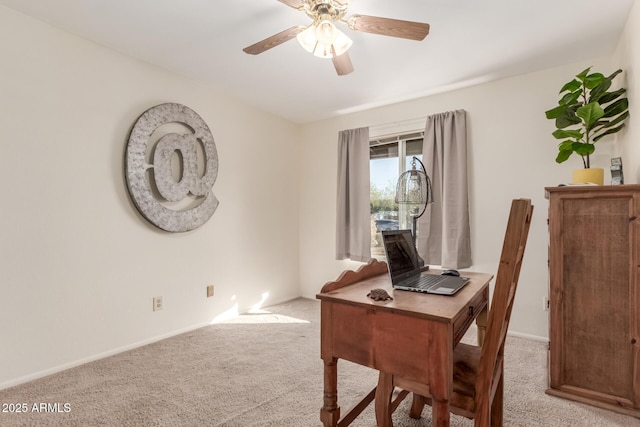 office space featuring light carpet and ceiling fan