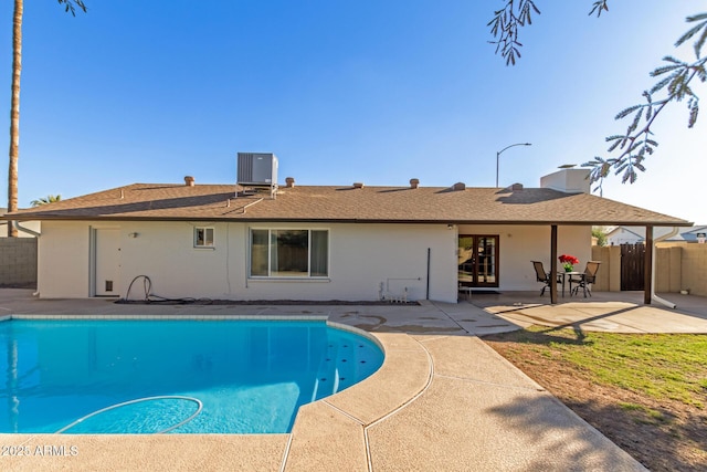 view of pool with a patio area and central AC unit