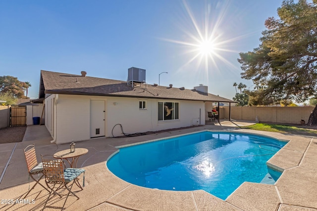 view of swimming pool with a patio and central air condition unit