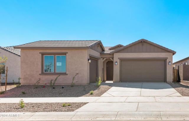 single story home featuring a garage, a tiled roof, concrete driveway, and stucco siding