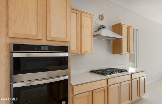 kitchen with light brown cabinetry and stainless steel appliances