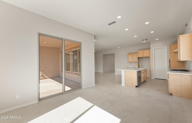 kitchen with appliances with stainless steel finishes, sink, and light brown cabinetry