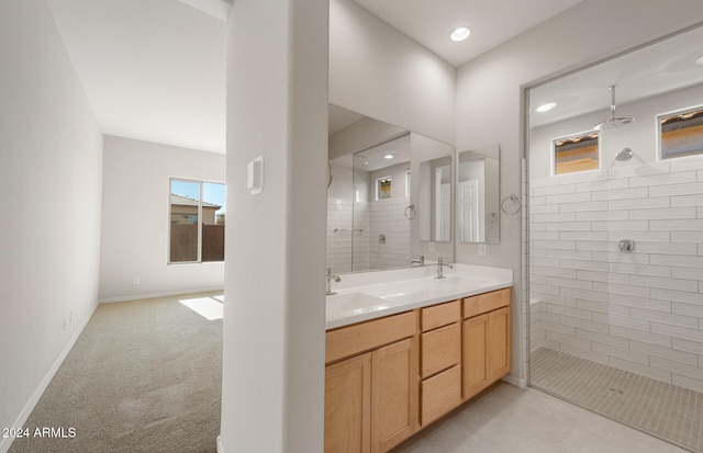 bathroom with vanity and tiled shower