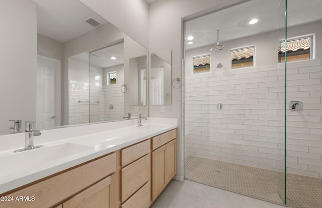 bathroom featuring vanity and a tile shower