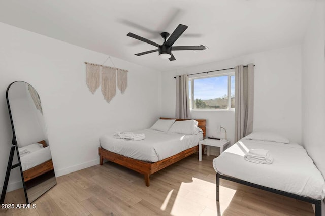 bedroom with ceiling fan and light hardwood / wood-style flooring