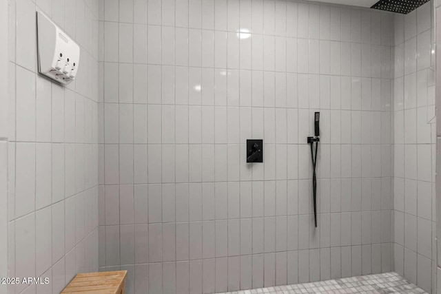 bathroom with a tile shower