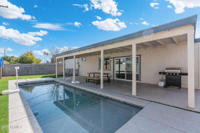 view of swimming pool with a grill and a patio