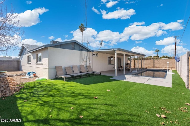 back of property featuring a yard and a patio area