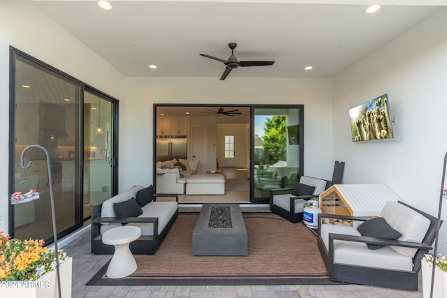 view of patio / terrace featuring an outdoor living space with a fire pit and ceiling fan