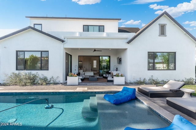 back of house featuring an outdoor living space, ceiling fan, a patio area, and a balcony