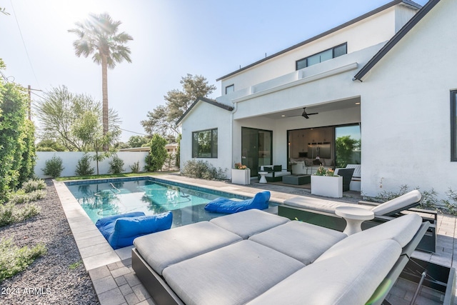 view of pool featuring an outdoor hangout area, a patio, and ceiling fan