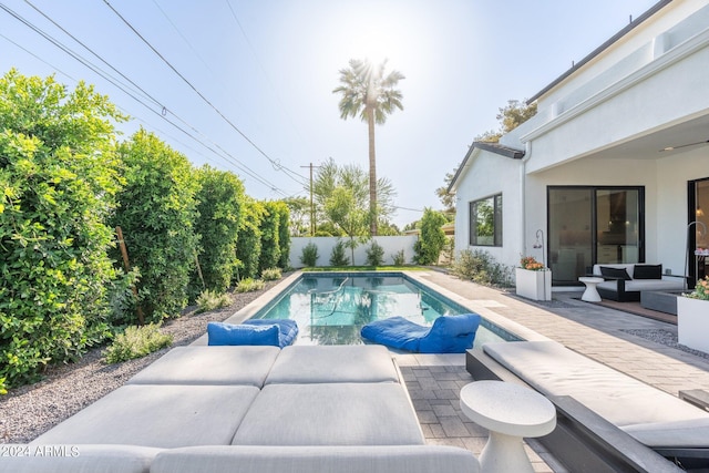 view of pool featuring outdoor lounge area and a patio