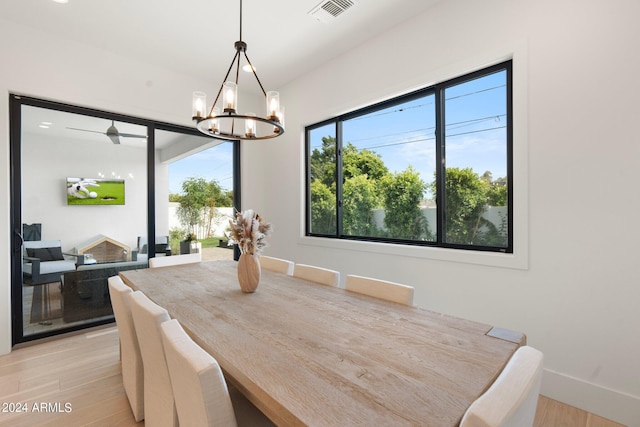 dining area featuring light hardwood / wood-style floors and a chandelier