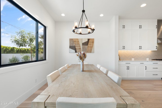 dining room with a chandelier and light hardwood / wood-style flooring