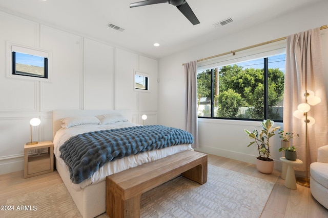 bedroom with ceiling fan and light hardwood / wood-style flooring