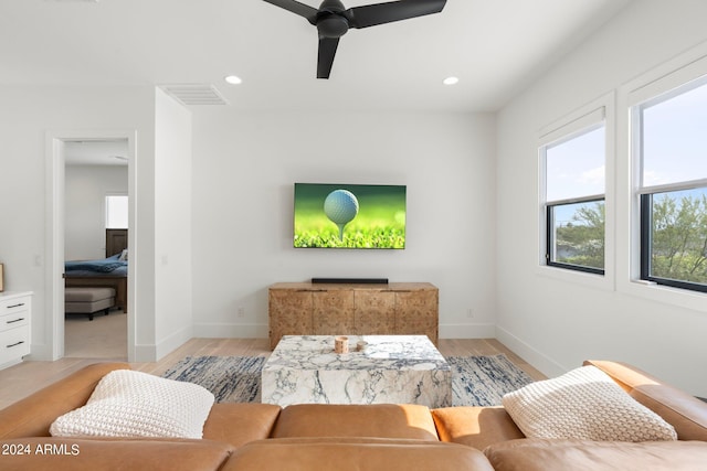 living room with light wood-type flooring and ceiling fan