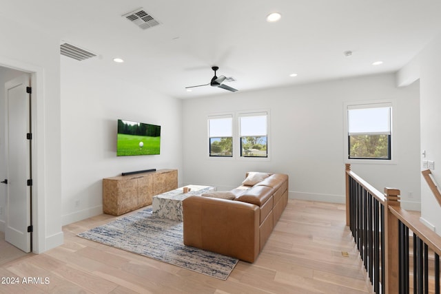 living room featuring ceiling fan and light wood-type flooring