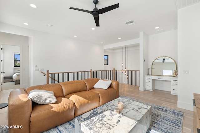 living room with ceiling fan and light hardwood / wood-style floors